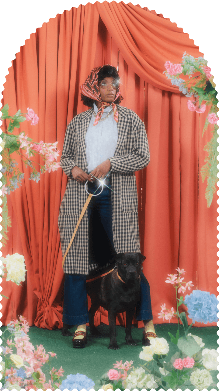 Photo of a young woman with a dog on a leash.